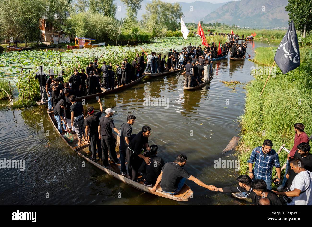 Kashmiri Shia Muslims hold religious flags and shout religious poems ...