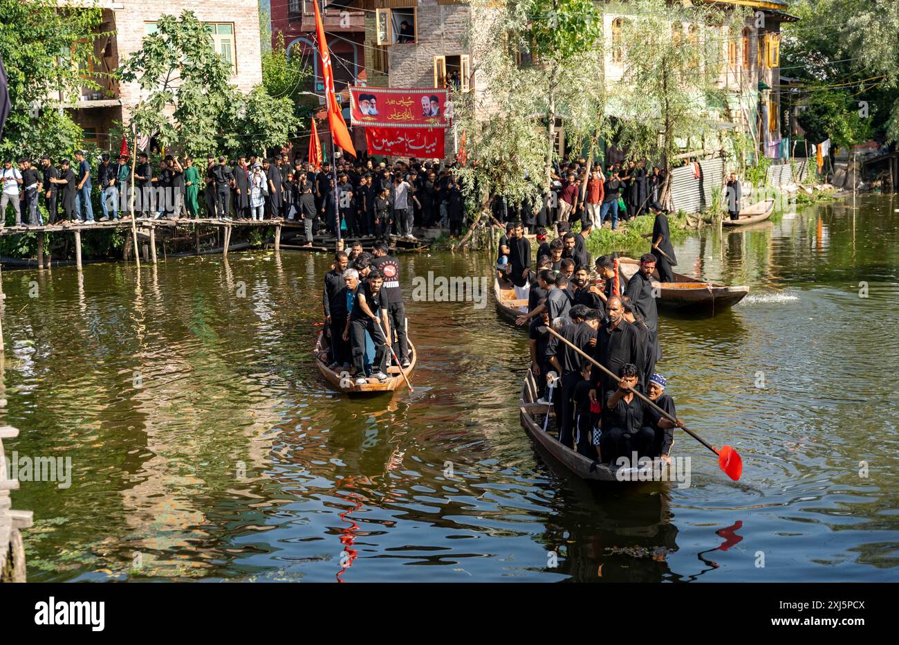 Kashmiri Shia Muslims hold religious flags and shout religious poems ...