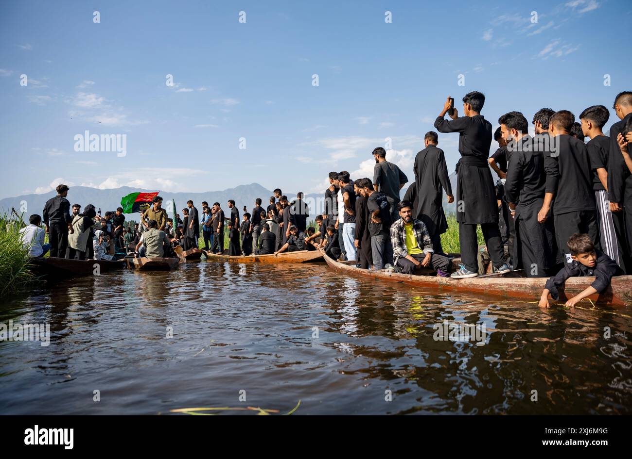 Kashmiri Shia Muslims wave religious flags and chant religious poems ...