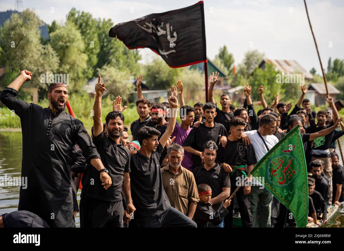 Kashmiri Shia Muslims wave religious flags and shout religious slogans ...