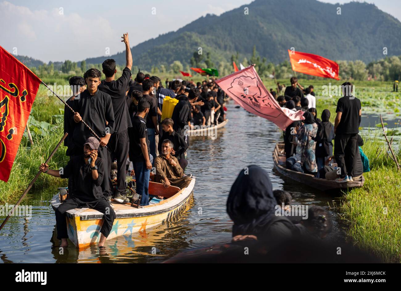 Kashmiri Shia Muslims wave religious flags and shout religious poems ...