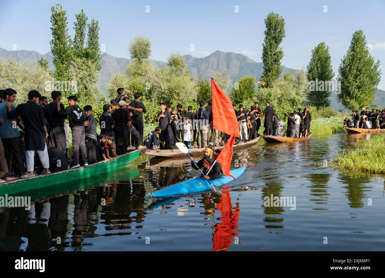 Kashmiri Shia Muslims hold religious flags and shout religious poems ...