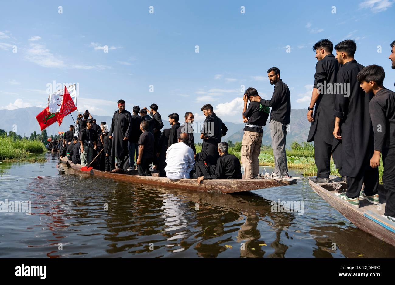 Kashmiri Shia Muslims hold religious flags and chant religious poems ...