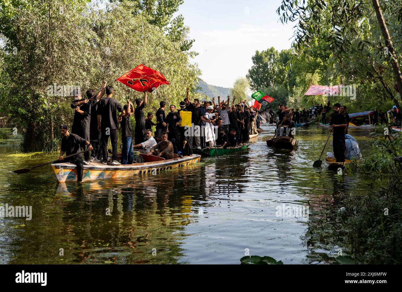 Kashmiri Shia Muslims hold religious flags and shout religious poems ...