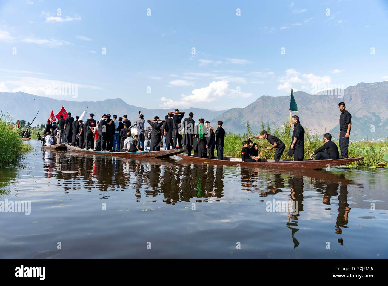 Kashmiri Shia Muslims hold religious flags and shout religious poems ...