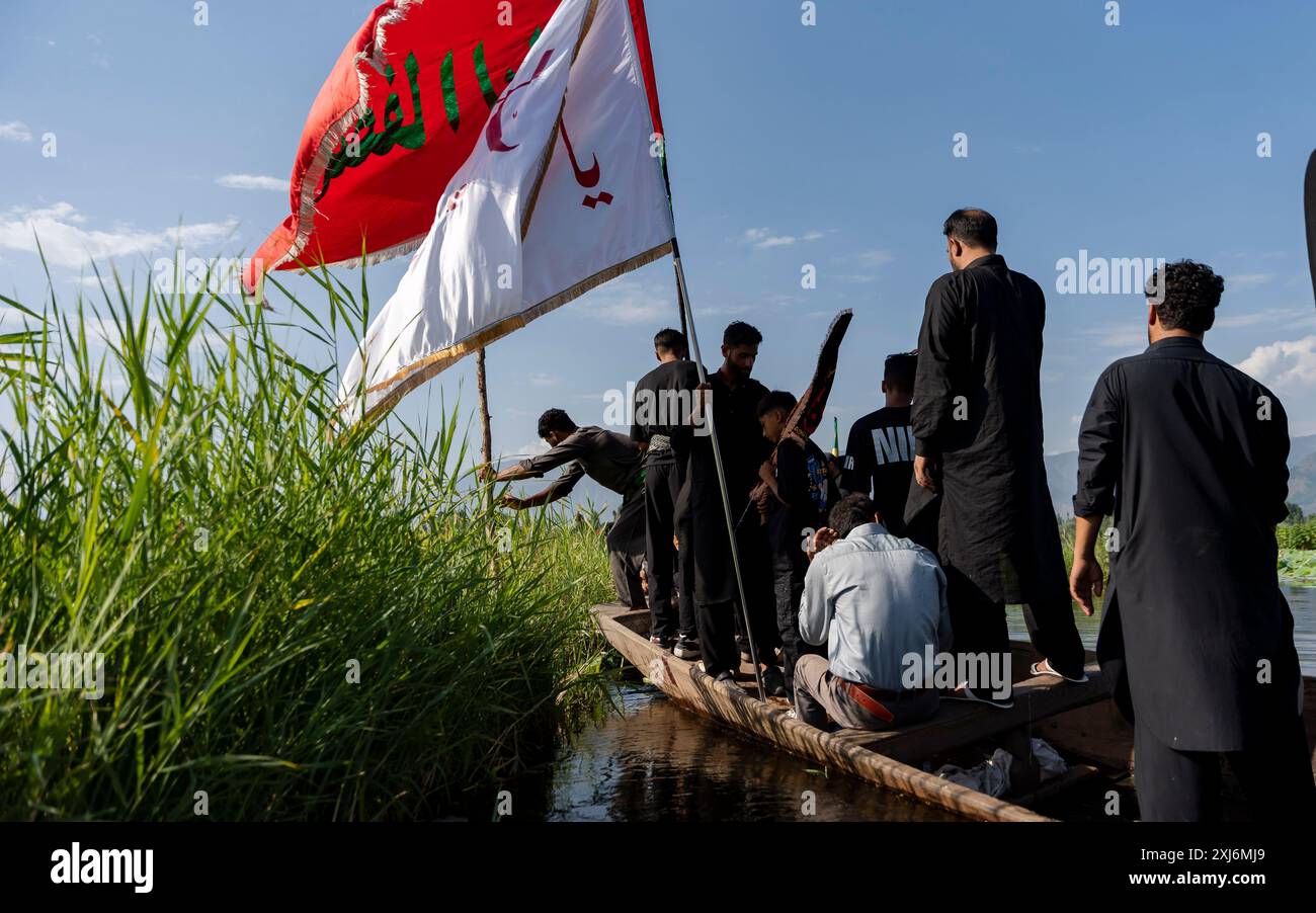 Kashmiri Shia Muslims hold religious flags and shout religious poems ...