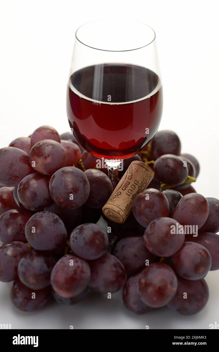 Glass of red wine,bunch of grapes and a wine bottle cork Stock Photo ...