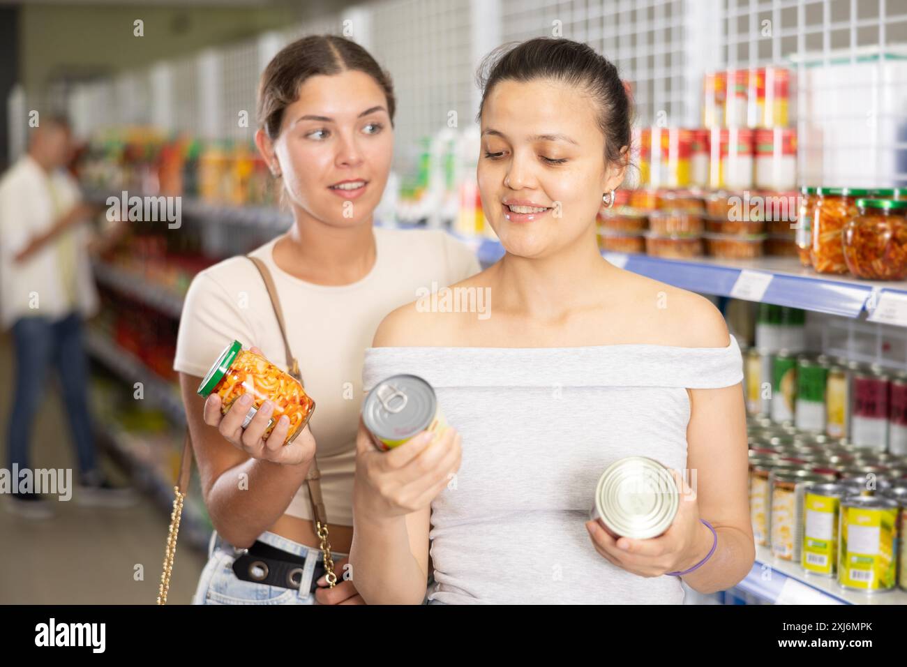 Female Friends Choosing Canned Vegetables At Asian Grocery Store Stock female-friends-choosing-canned-vegetables-at-asian-grocery-store-stock