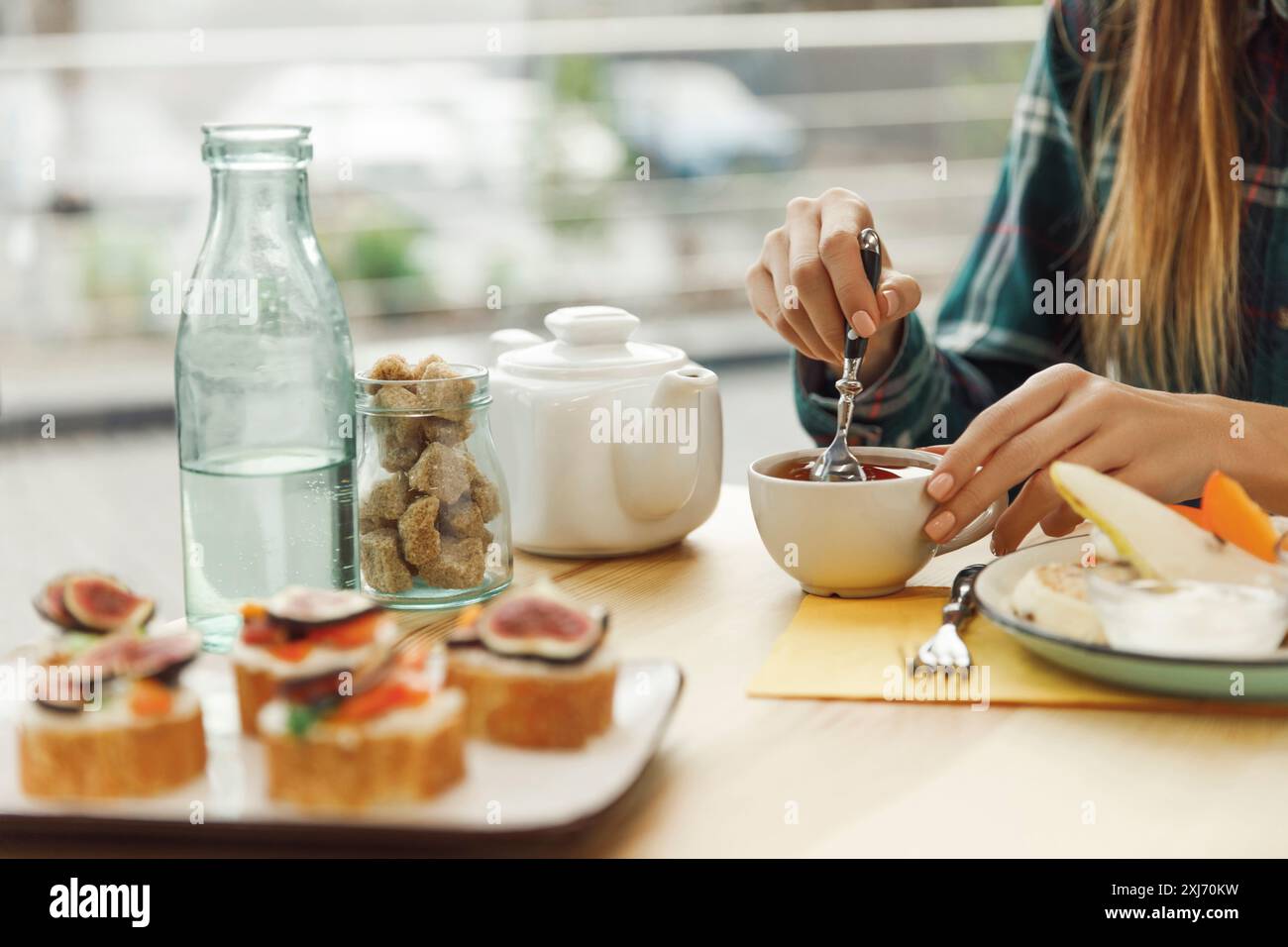 cropped shot of girl drinking tea while having breakfast Stock Photo