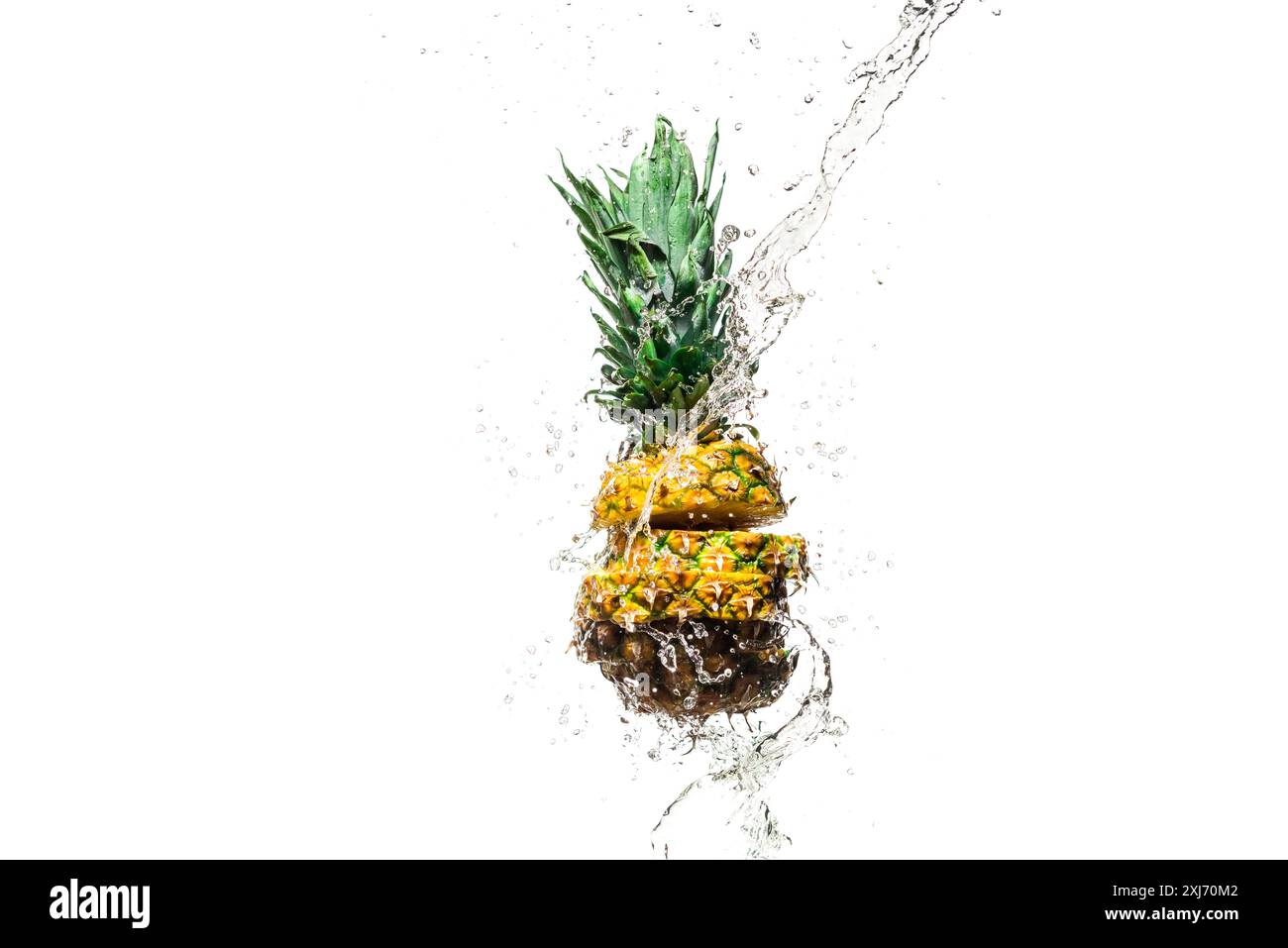 fresh sliced pineapple in water splashes isolated on white Stock Photo