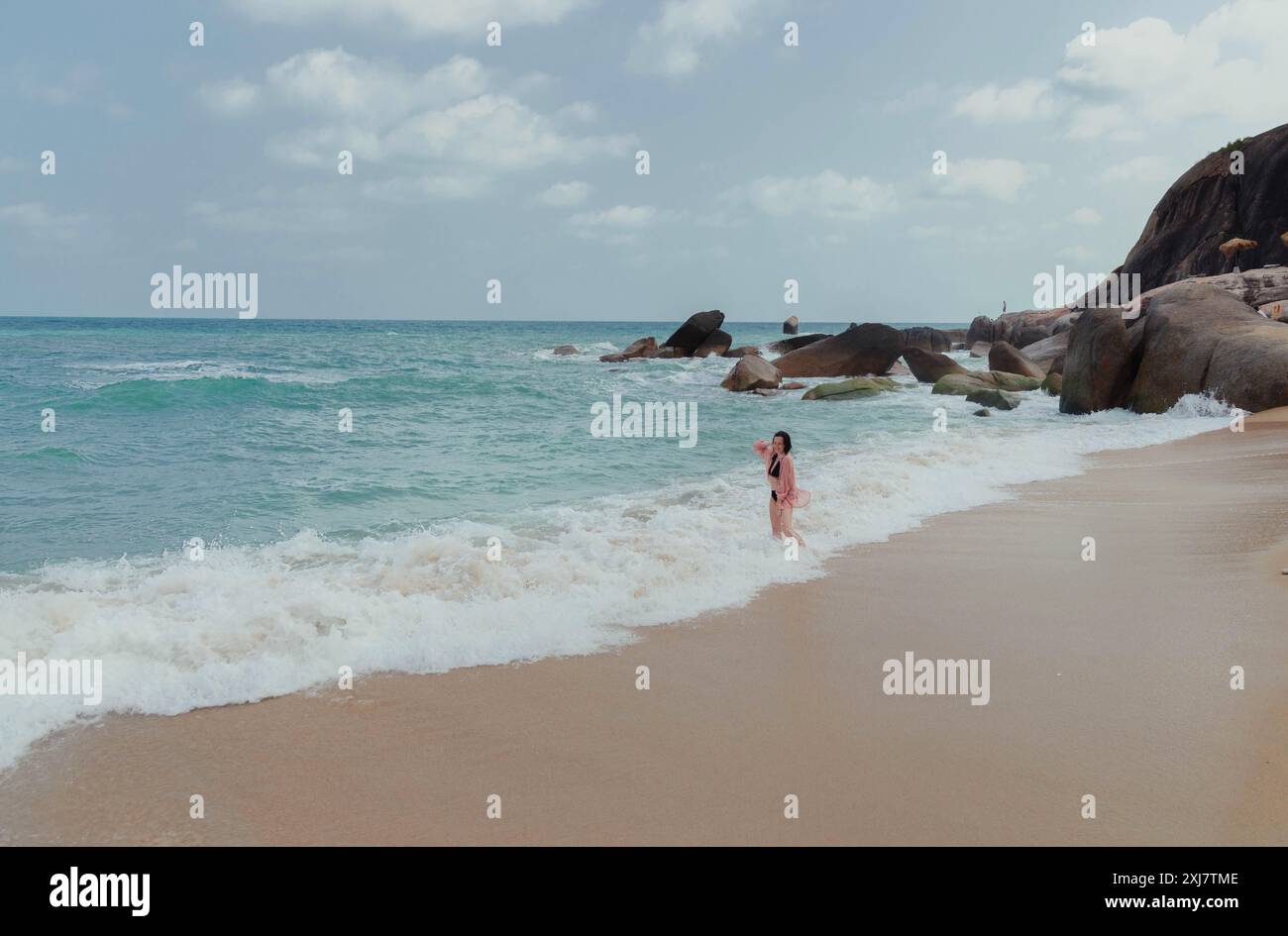 Woman walking on foamy shore hi-res stock photography and images - Alamy