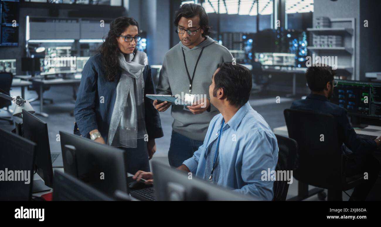 Team of Three Young Indian Software Engineers Use Computer to Discuss a ...