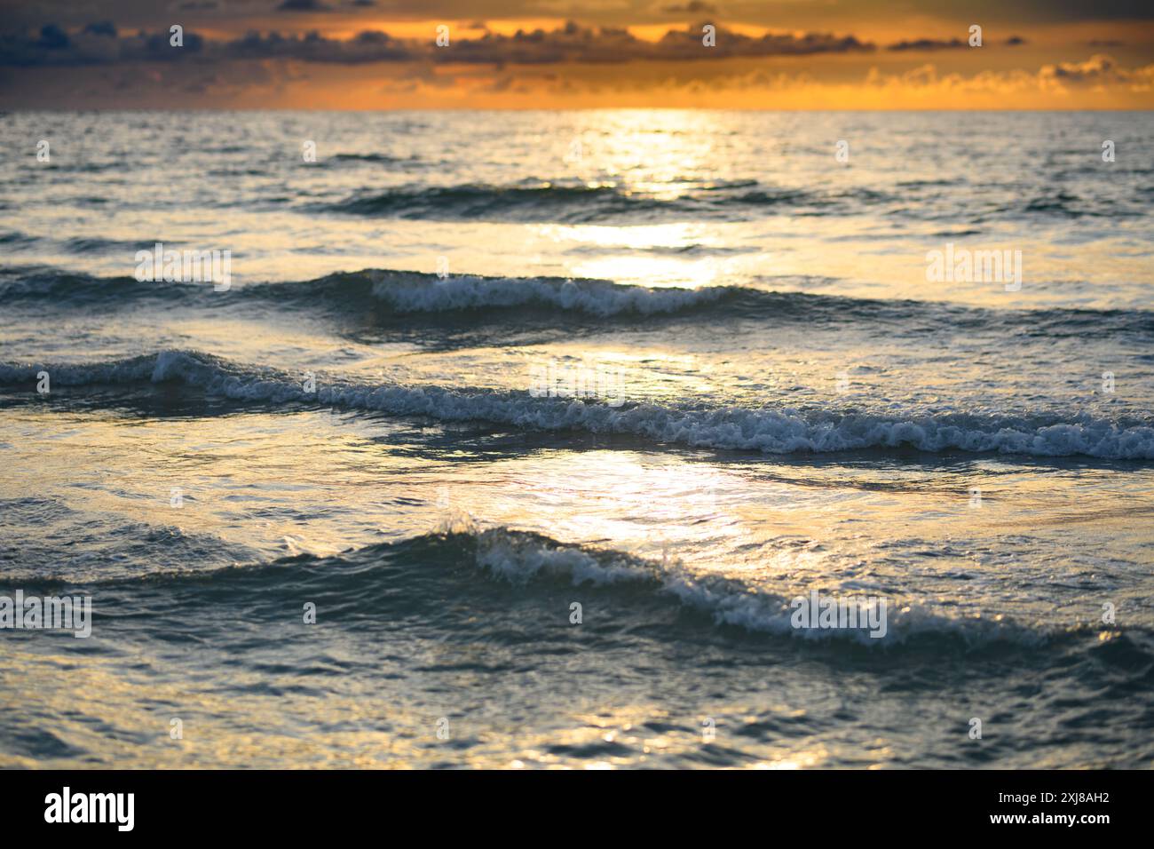 Golden ocean beach sunrise splashing hi-res stock photography and ...