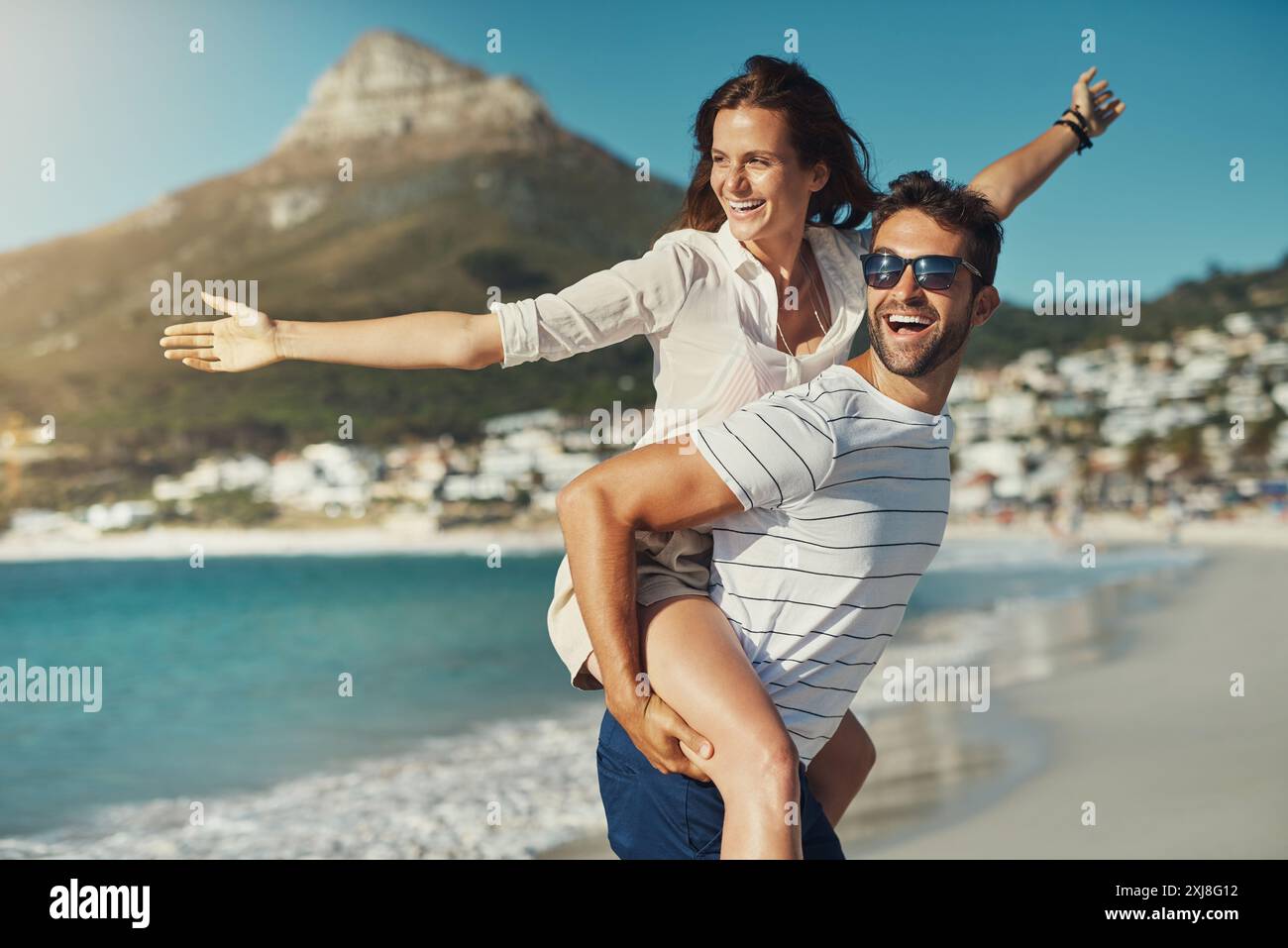 Smile, couple and piggyback on beach for love, commitment and bonding ...