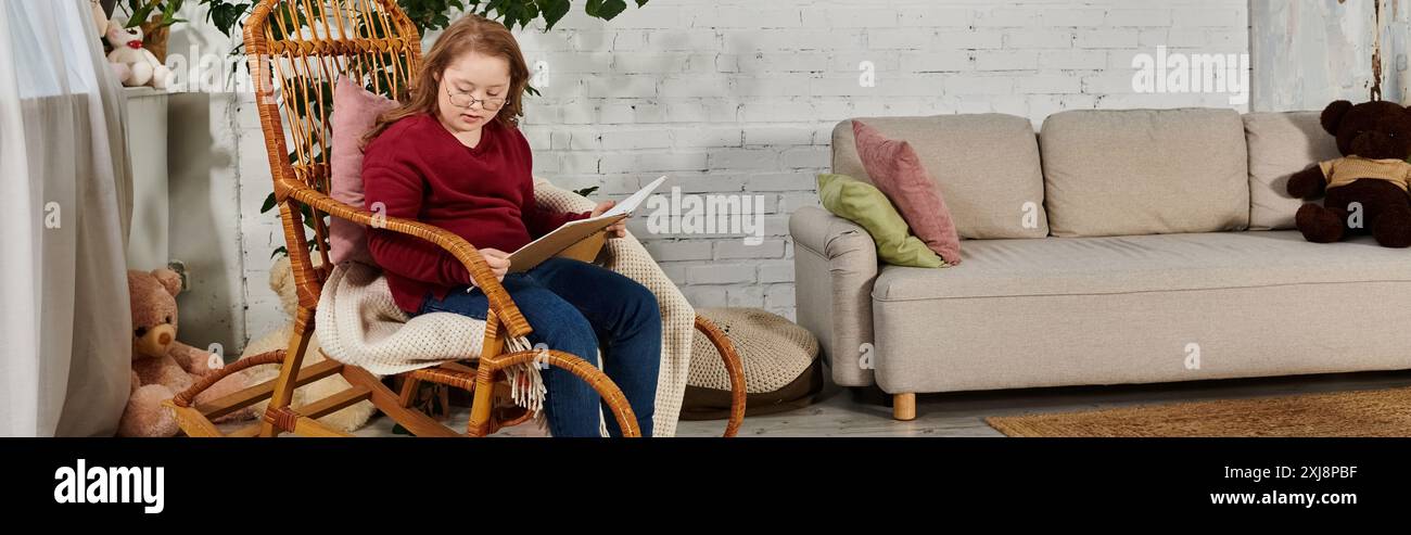 A little girl sits in a wicker rocking chair at home, reading a book ...