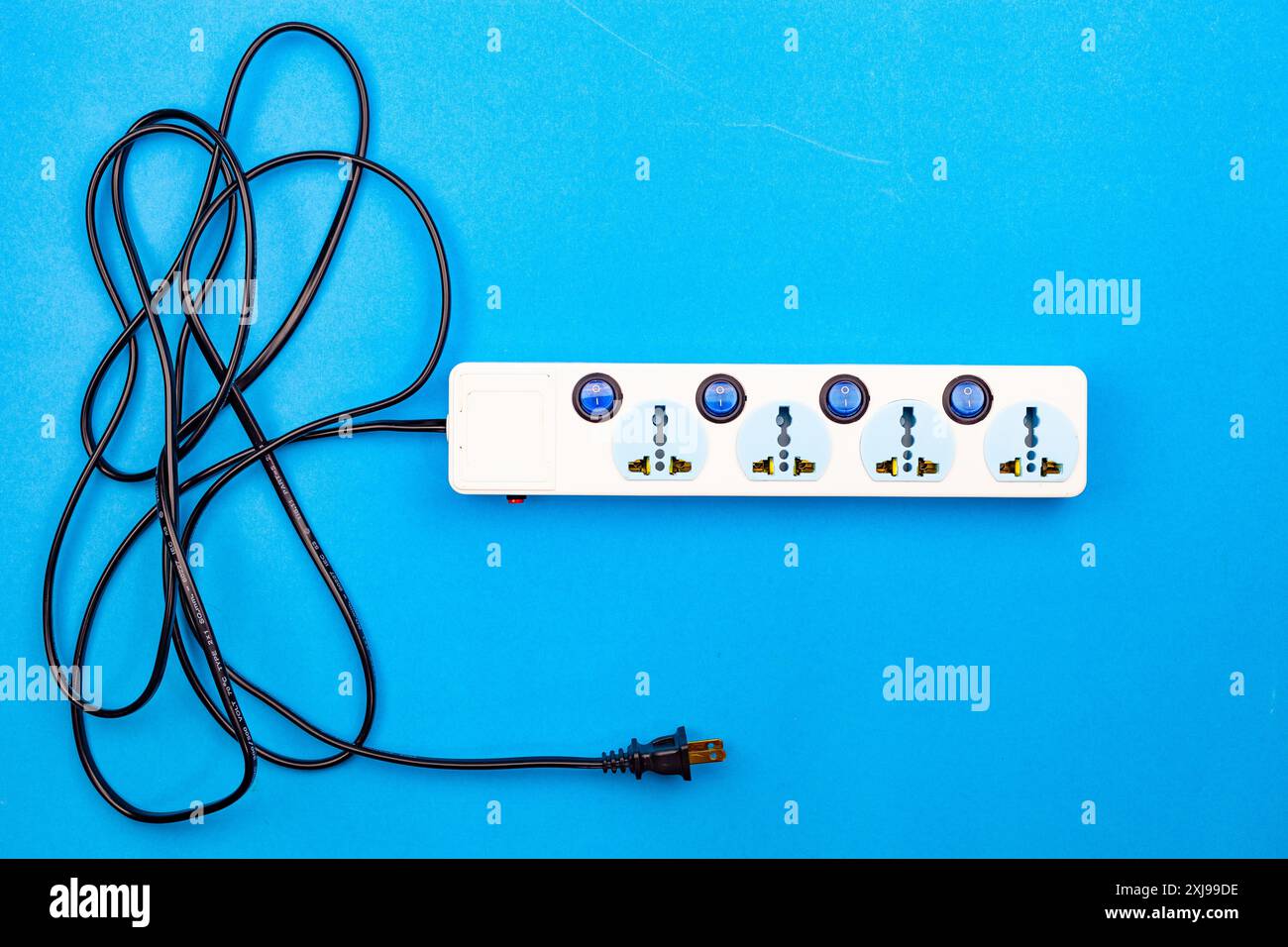 Electric power socket and plug on blue paper background Stock Photo