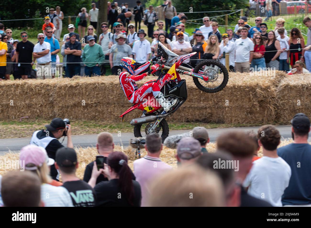 Sam Sunderland, rally raid biker riding a motorcycle up the hill climb track at the Goodwood Festival of Speed 2024 motorsport event, UK Stock Photo