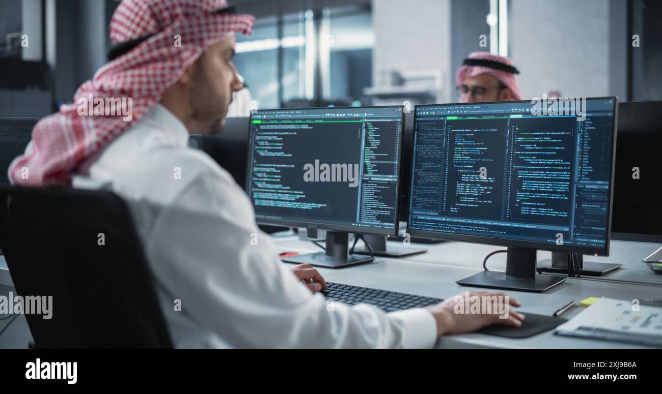 Arab Telecommunications Manager Working in a Research and Development Facility on a Desktop Computer. Focused Middle Eastern Software Engineer Updating Server System Database Stock Photo
