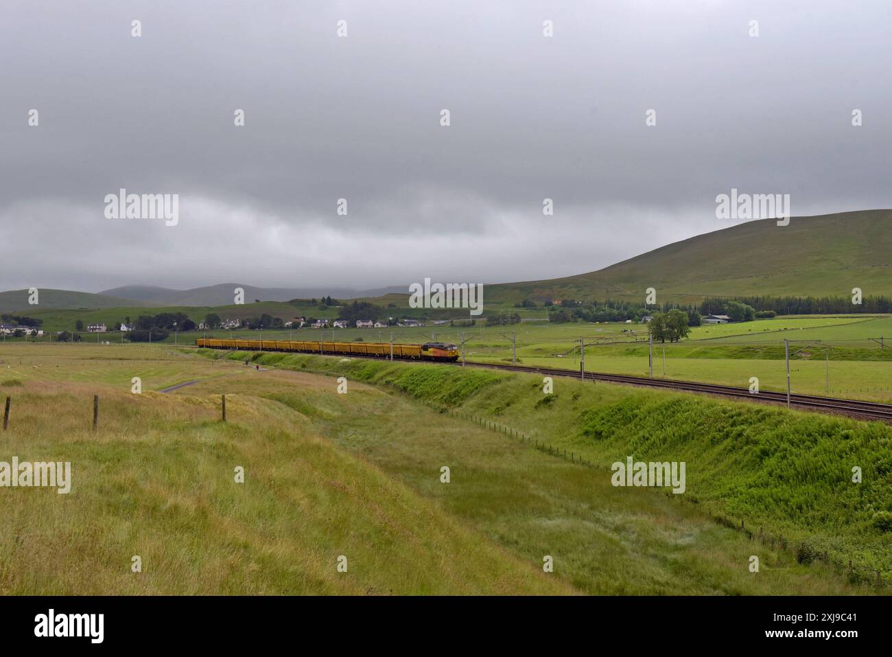 Colas Rail Freight 56105 with empty aggregate wagons heading north on the West Coast Main Line near Beattock, Scotland, UK. 3rd July 2024 Stock Photo