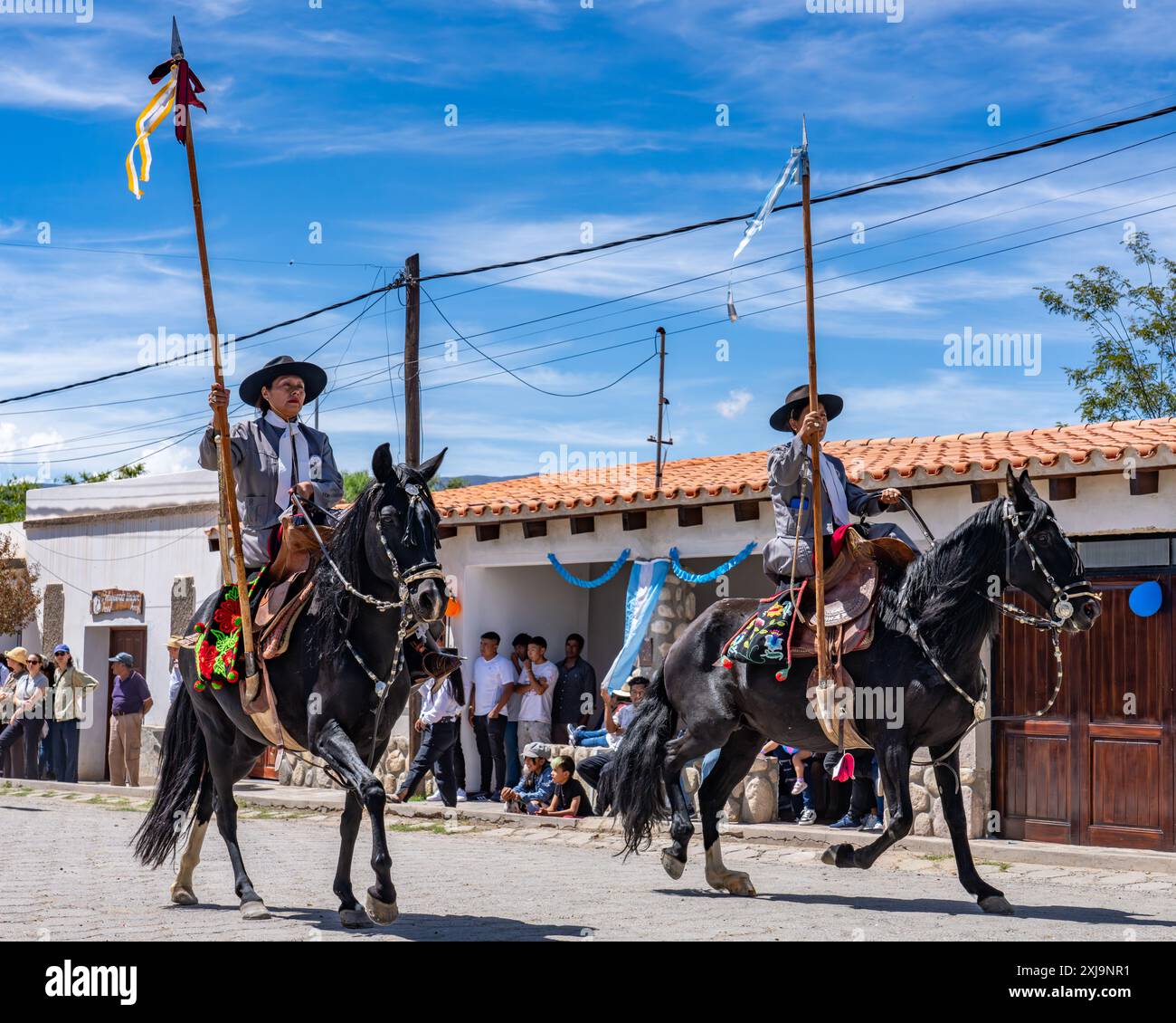 Two female gauchos in traditional dress ride sidesaddle in a parade in ...