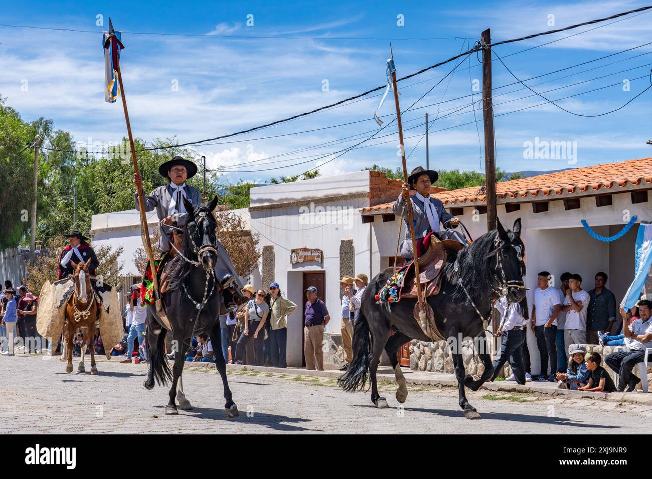 Two female gauchos in traditional dress ride sidesaddle in a parade in ...