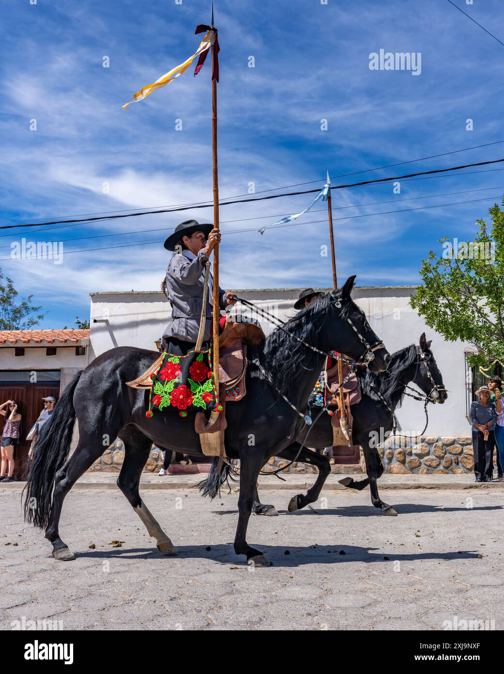 Two female gauchos in traditional dress in a parade in Cachi, Argentina ...