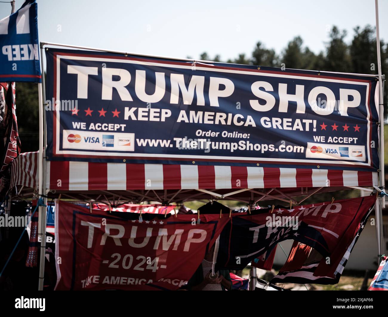 A temporary road-side sales tent featuring items related to Donald Trump and his 2024 election bid to be re-elected as President. Stock Photo