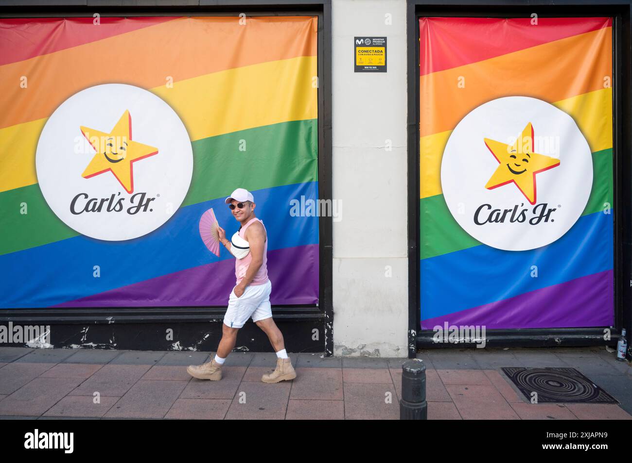 A man walks past the American fast food restaurant chain Carl's Jr ...