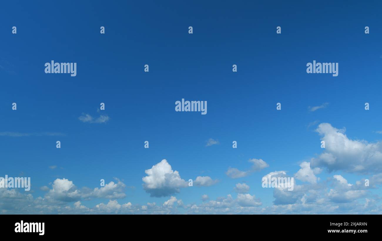 Time lapse. Puffy fluffy white cloud. Summer blue sky background Stock ...