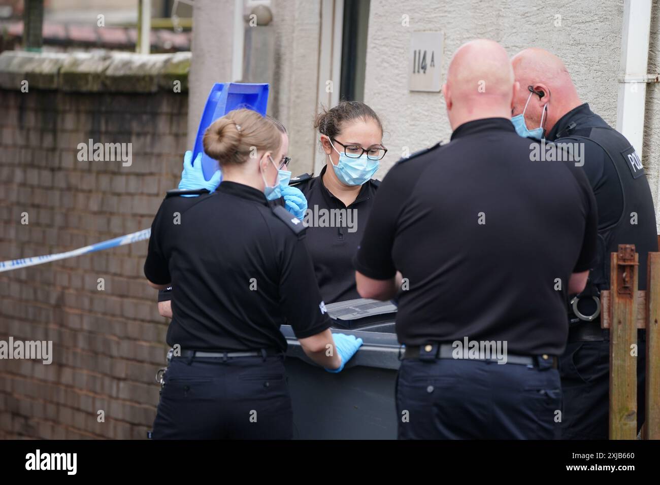 Police officers searching near a house in Blackpool after a man and a ...