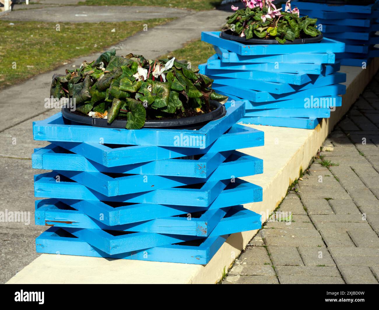 Decorating a flowerpot with colored slats Stock Photo