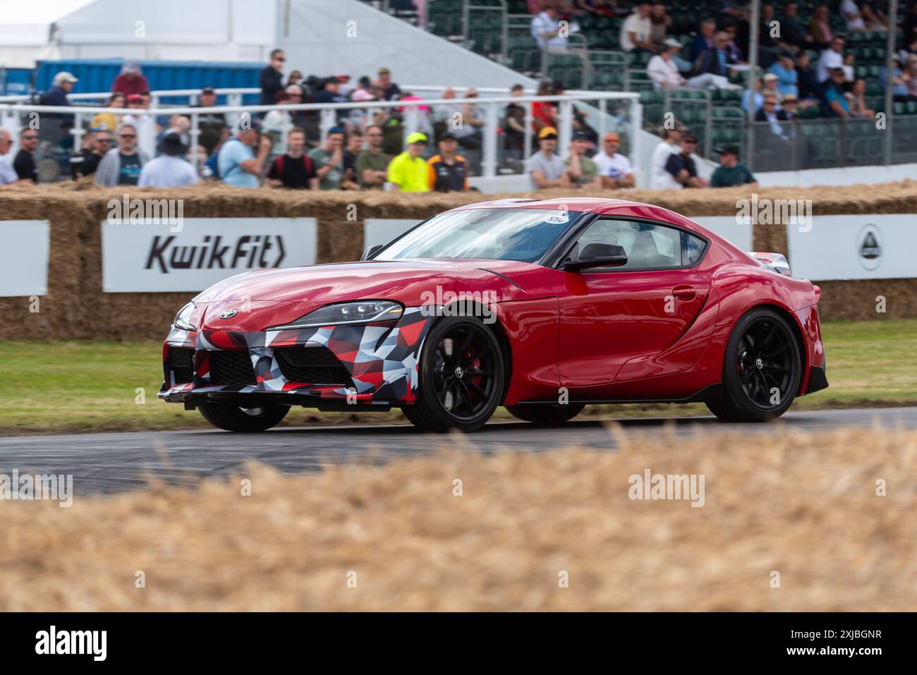 Toyota Supra sports car driving up the hill climb track at the Goodwood Festival of Speed 2024 motorsport event, West Sussex, UK Stock Photo
