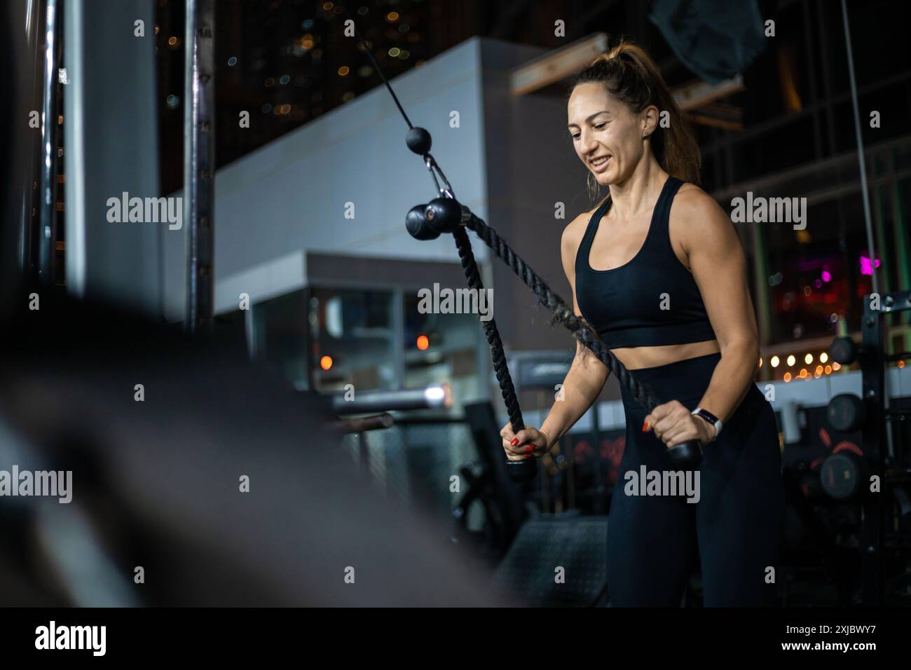 Woman Doing Cable Rope Bicep Curls In Gym During Workout Stock Photo ...