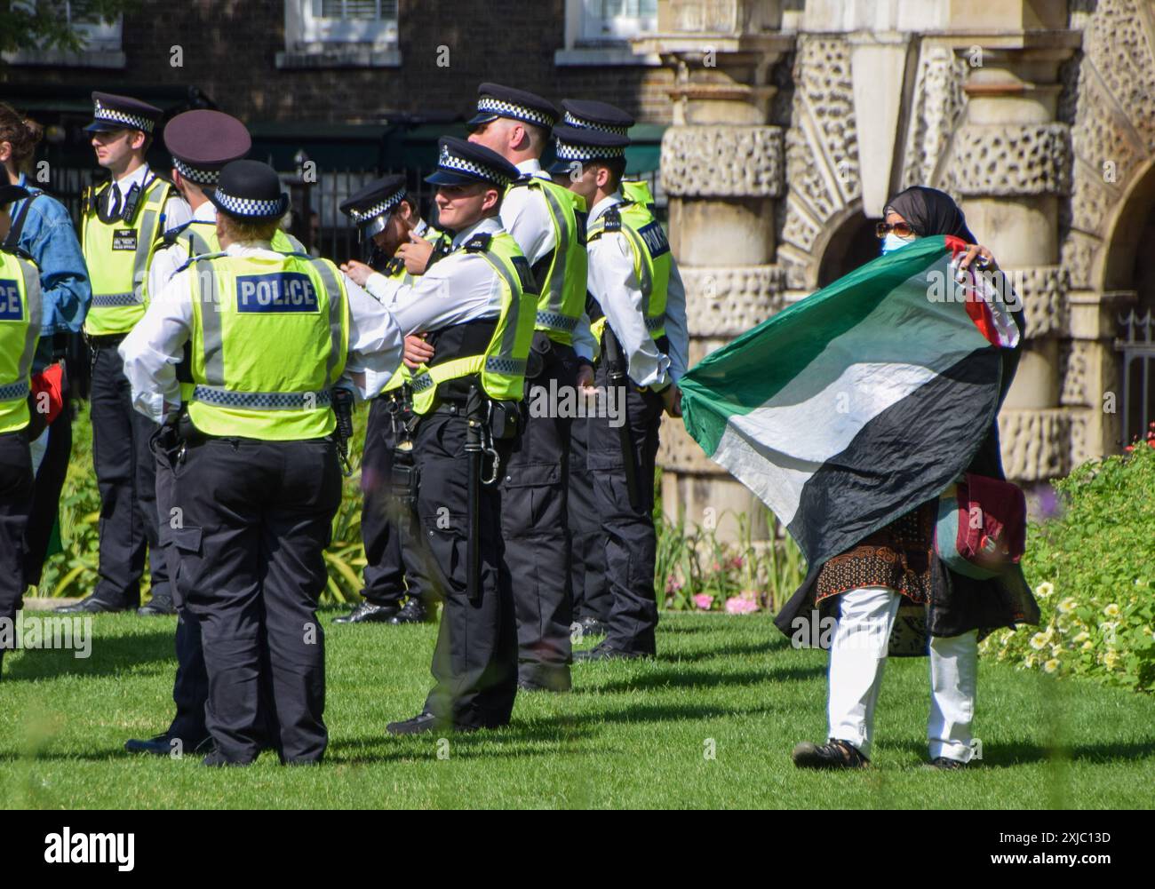 London, England, UK. 17th July, 2024. A woman waves a Palestinian 