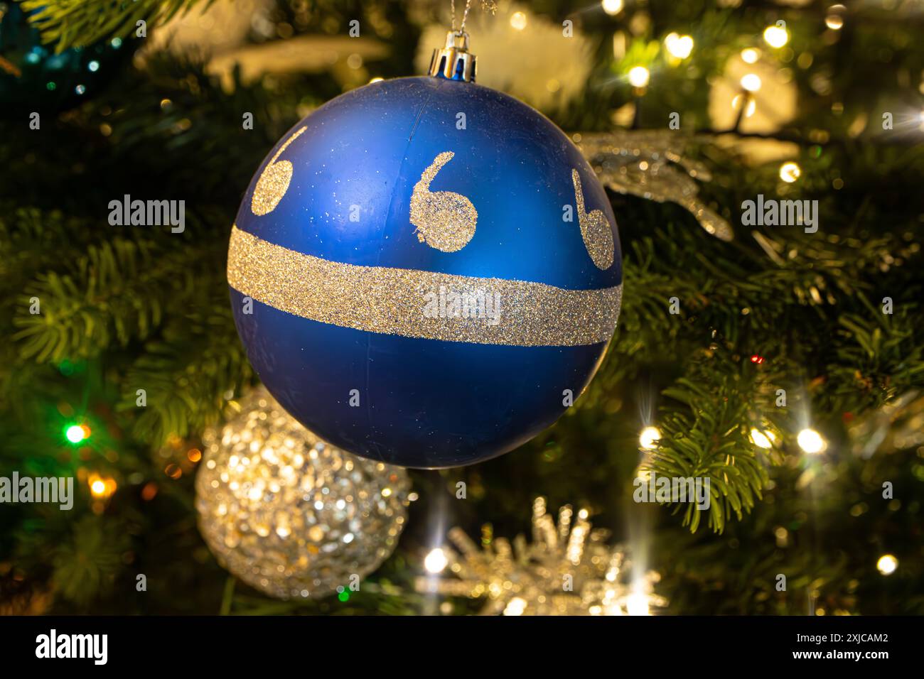Closeup of a blue and silver bauble hanging on a Christmas tree Stock ...