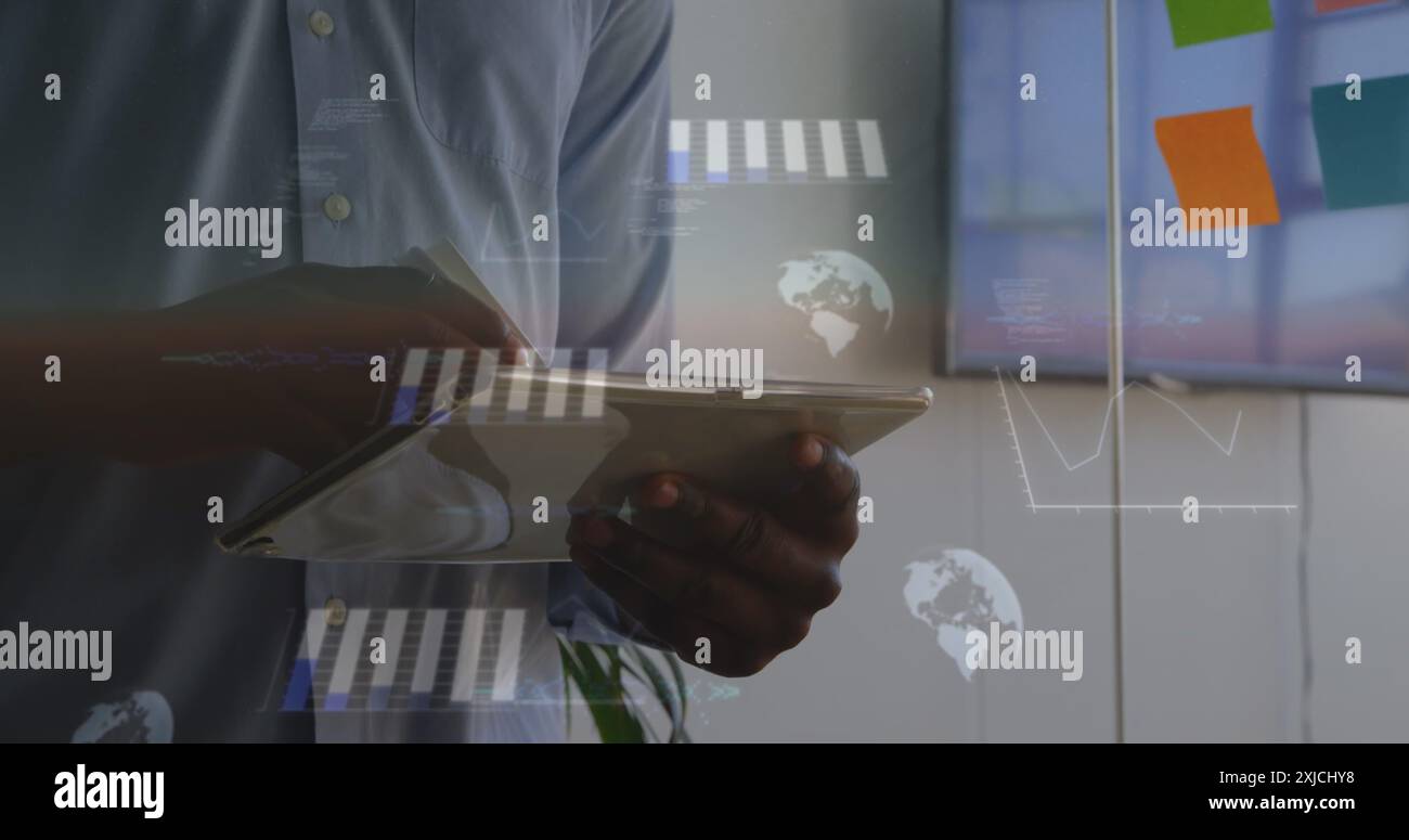 Image of statistical data processing against mid section of a man using tablet at office Stock Photo