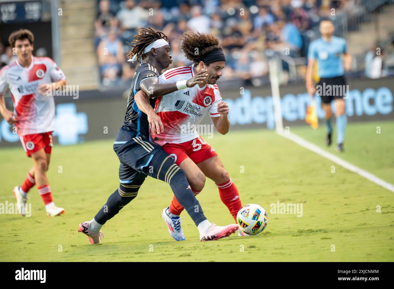 Chester, Pennsylvania, USA. 17th July, 2024. Philadelphia Union player, OLIVER MBAIZO (15) fights for the ball against the New England Revolution player, RYAN SPAULDING (34) during the match (Credit Image: © Ricky Fitchett/ZUMA Press Wire) EDITORIAL USAGE ONLY! Not for Commercial USAGE! Stock Photo