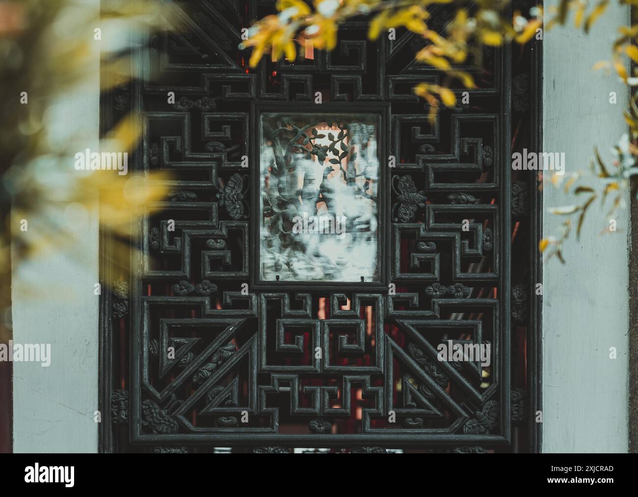 A close-up view of an intricately carved wooden window frame in a ...