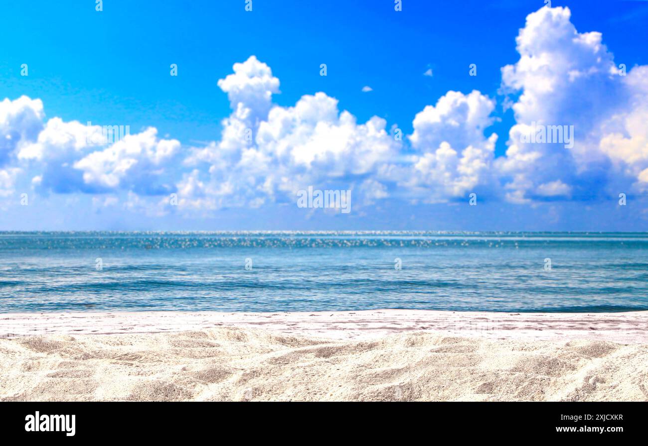 sand beach with blue ocean wave and cloudy blue sky Stock Photo - Alamy