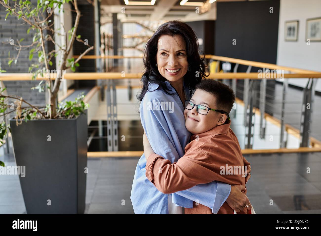 A mother and son with Down syndrome share a loving embrace in a ...