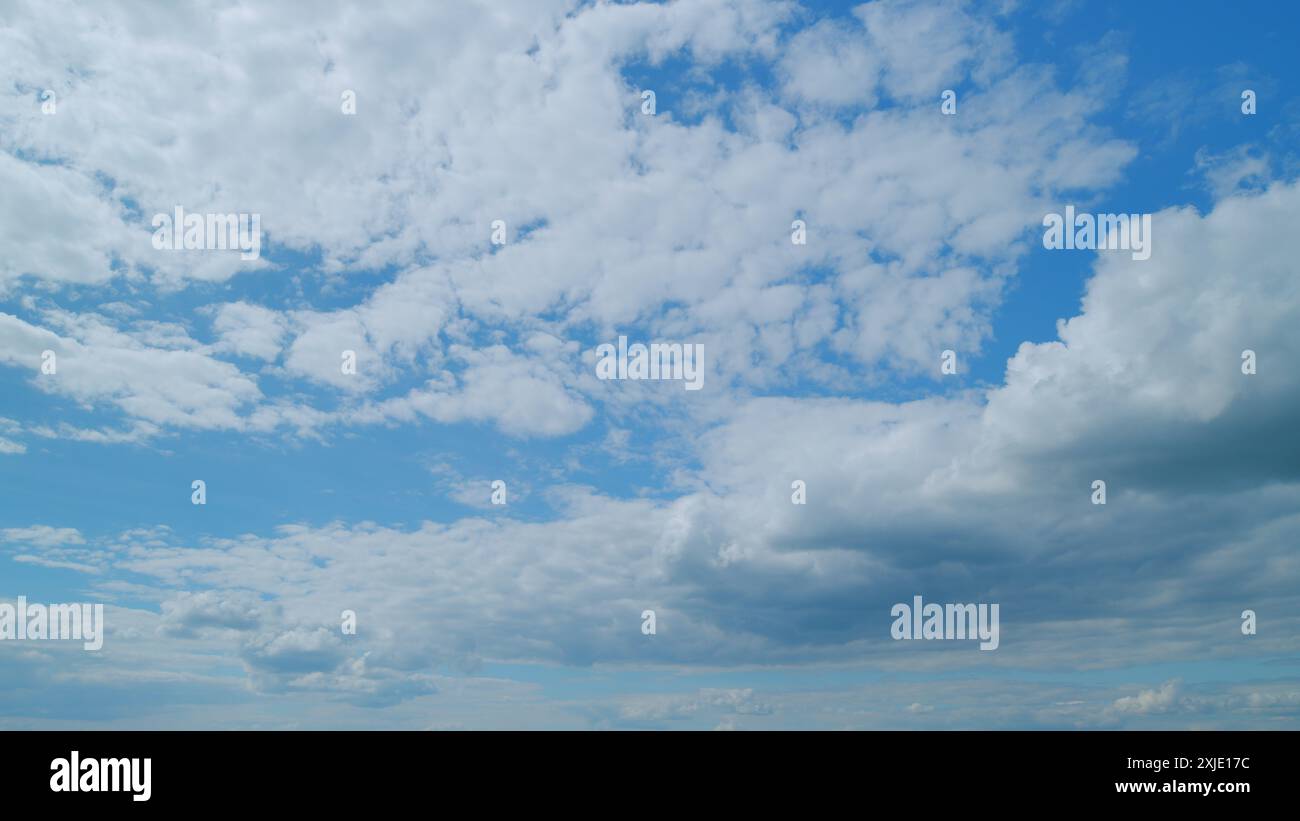 Time lapse. Puffy fluffy white cloud. Summer blue sky background Stock ...