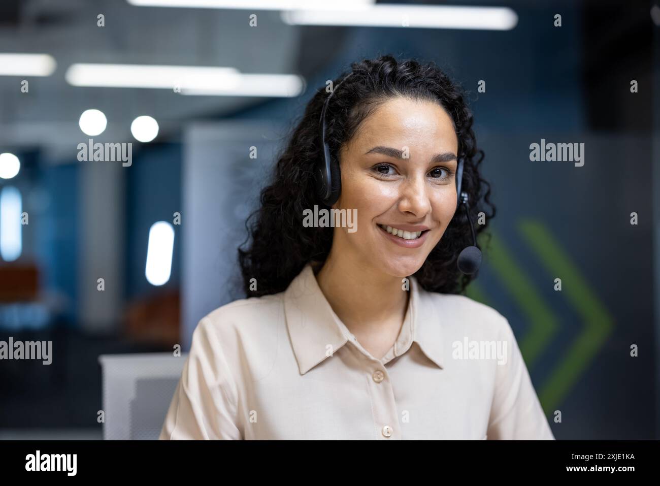 Friendly customer service representative with headset smiling in modern ...