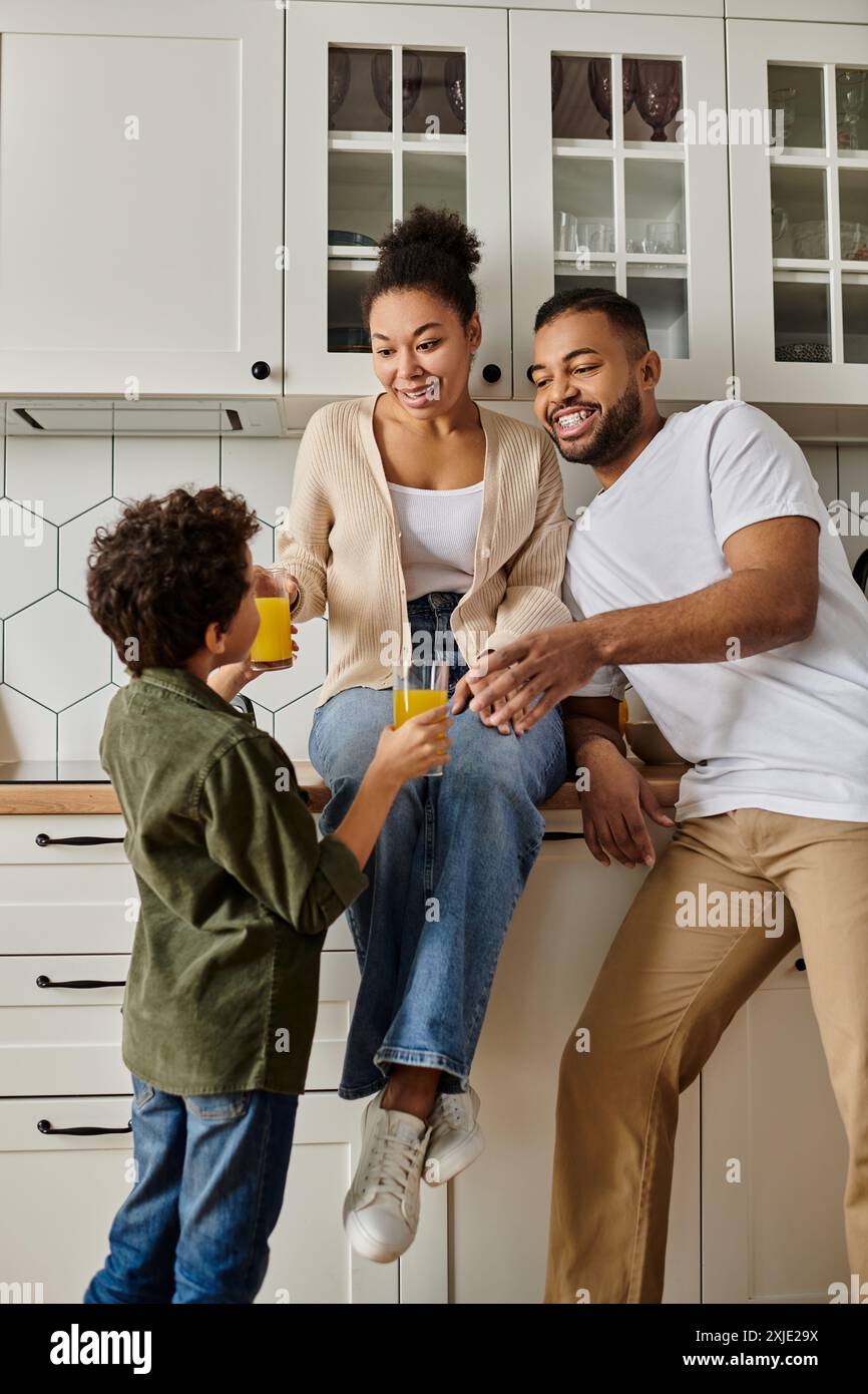 African American man, woman, child laughing on counter Stock Photo - Alamy