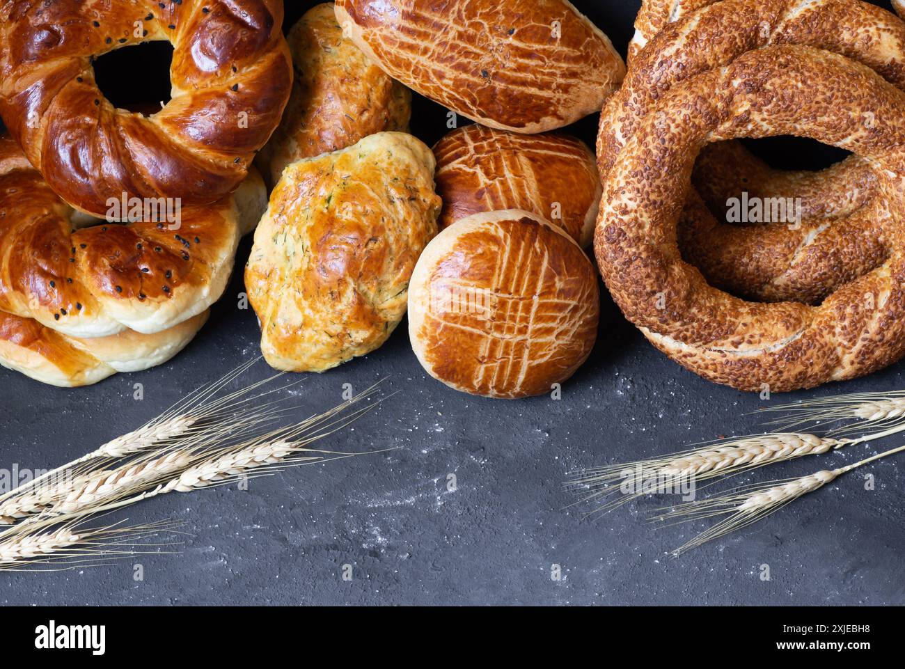 Traditional Turkish pastry concept, pogaca , bagel, on rustic table, famous bakery product Stock Photo