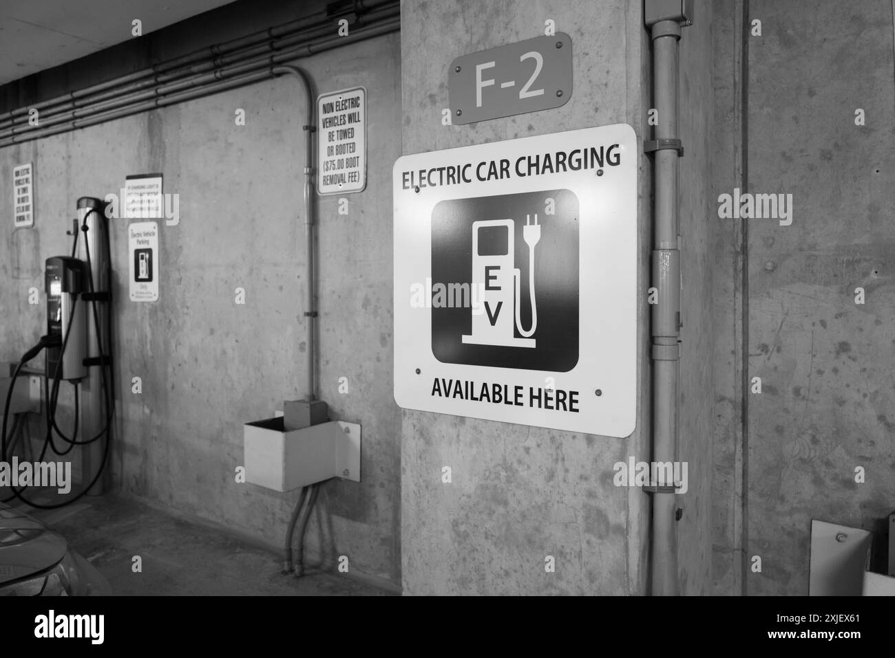 Electric vehicle charging station in a indoor parking garage in Ann Arbor Michigan USA Stock Photo