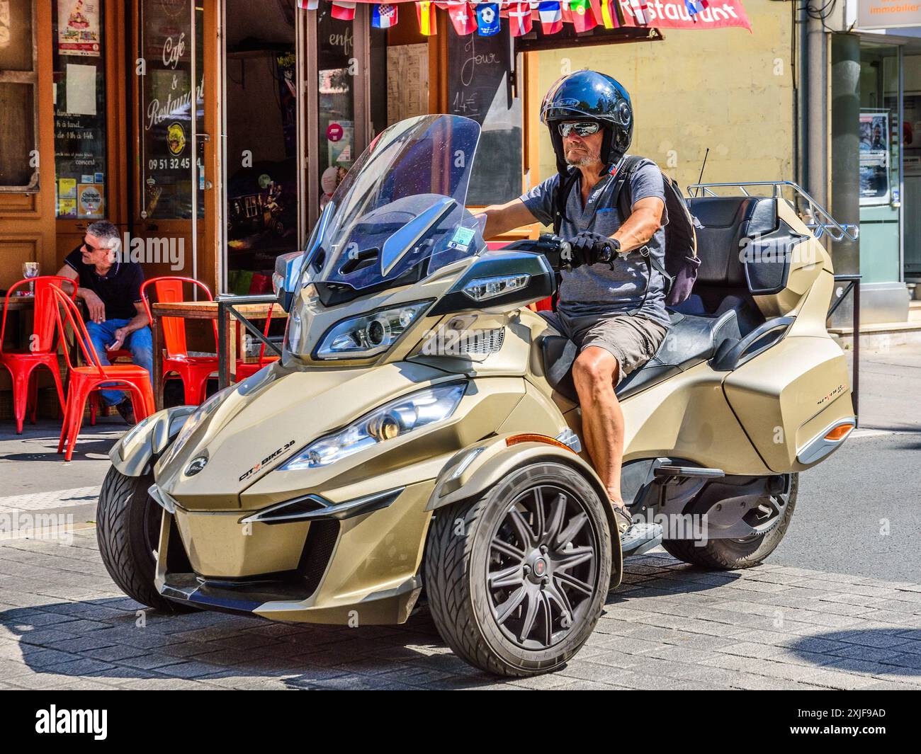 Expensive BRP 'City Bike 3B' 3-wheel motorcycle cruising through city center - Chatellerault, Vienne (86), France. Stock Photo