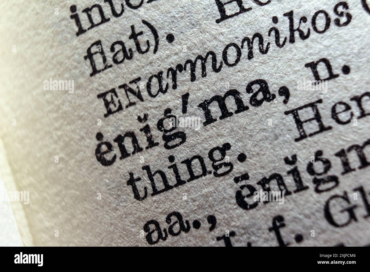 Word enigma on dictionary page, macro close-up Stock Photo