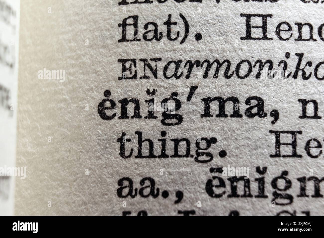 Word enigma on dictionary page, macro close-up Stock Photo