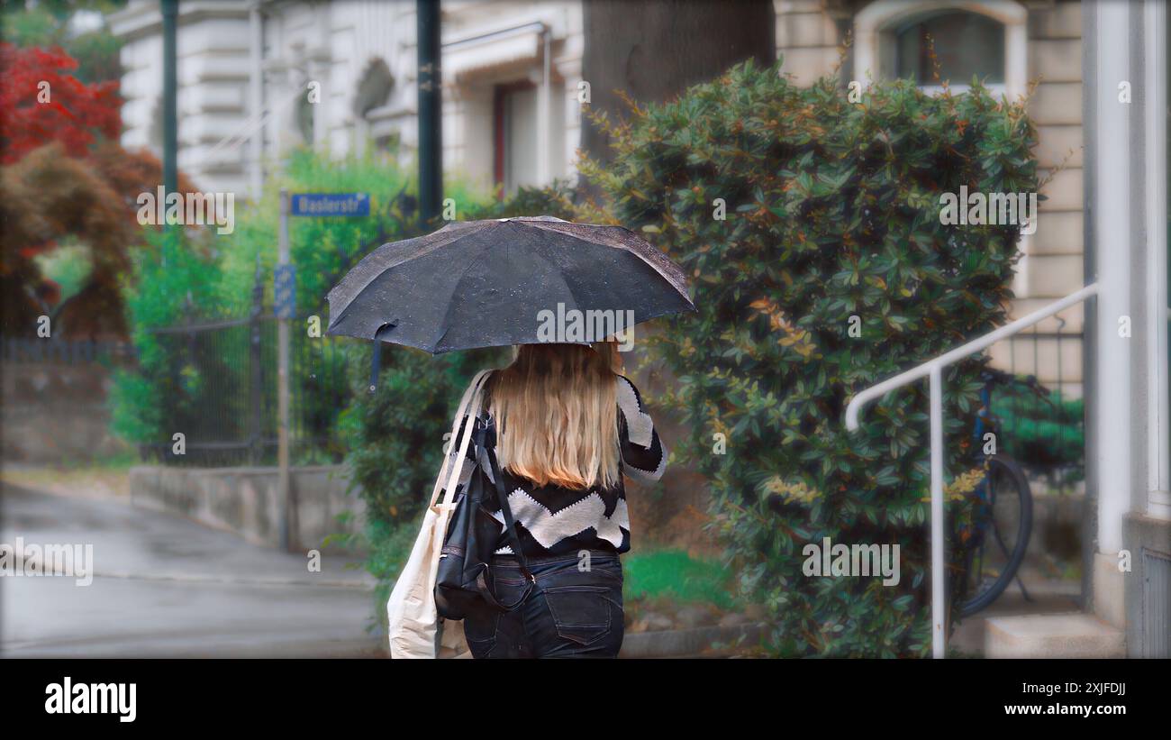 Young woman with umbrella on the street Stock Photo - Alamy
