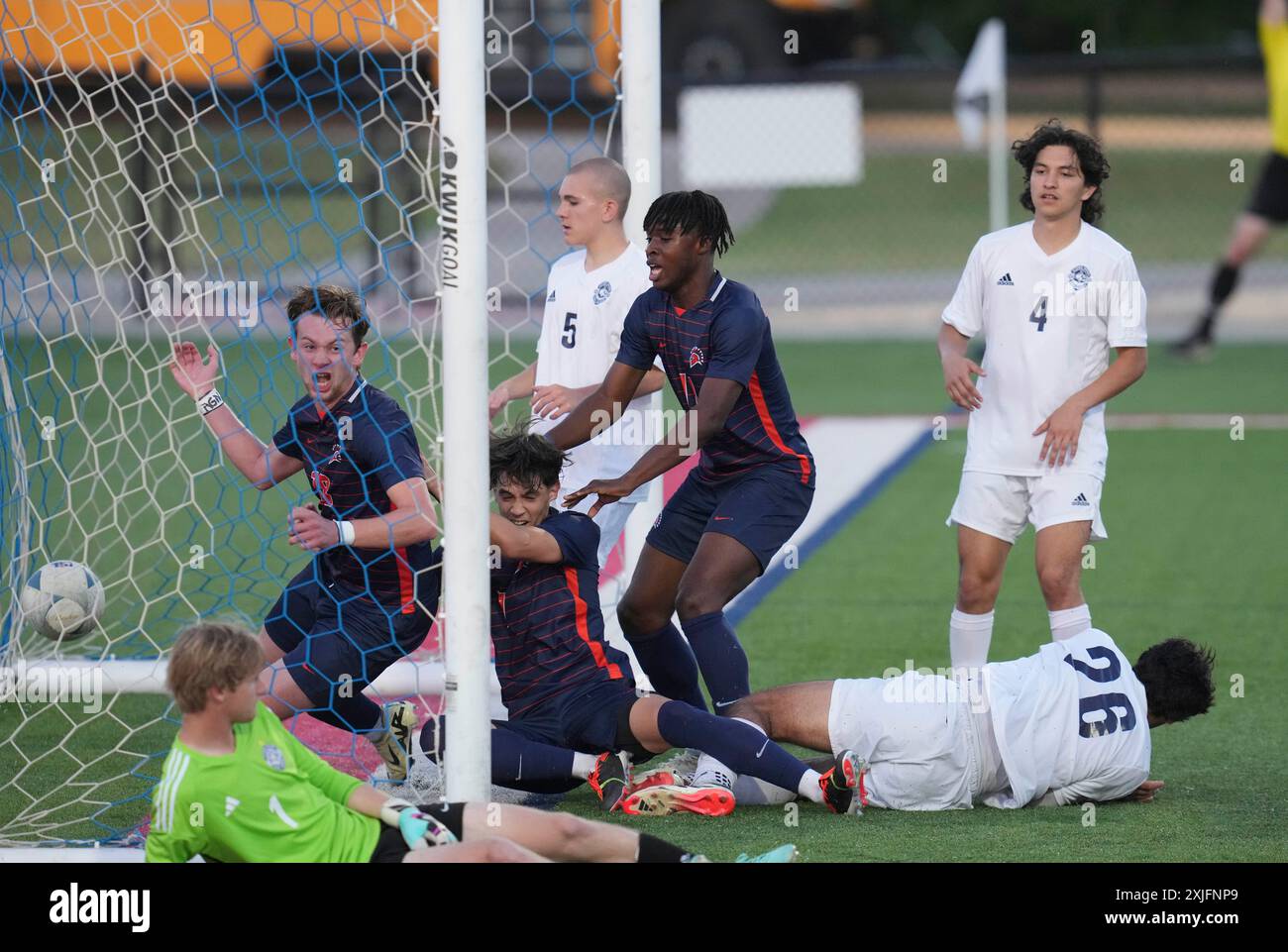 Seven Lakes players (dark jerseys) crowd the Flower Mound goal during a